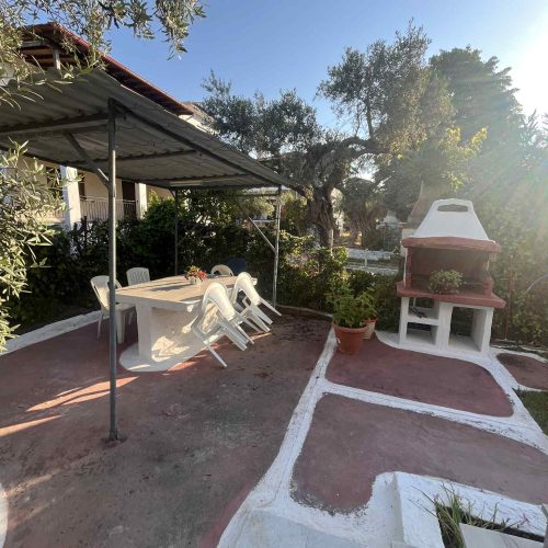 Seating spot with grill and a table that hosts many guests